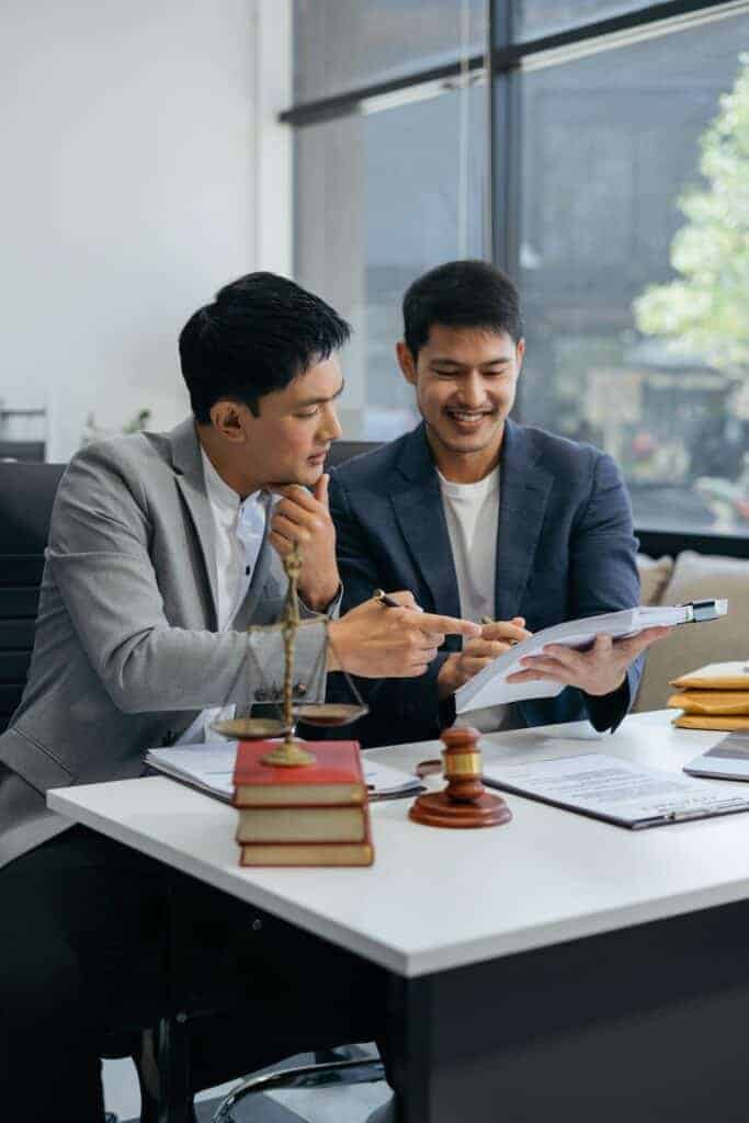 Estate planning lawyer reviewing documents with clients in Perth office. Clairs Keeley Lawyers specializing in wills, estates and probate.