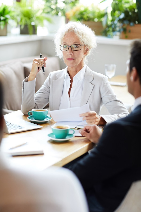 Perth Lawyer reviews business plans over coffee. Wills & Estates legal advice in East Perth from Clairs Keeley Lawyers. Expert estate planning.