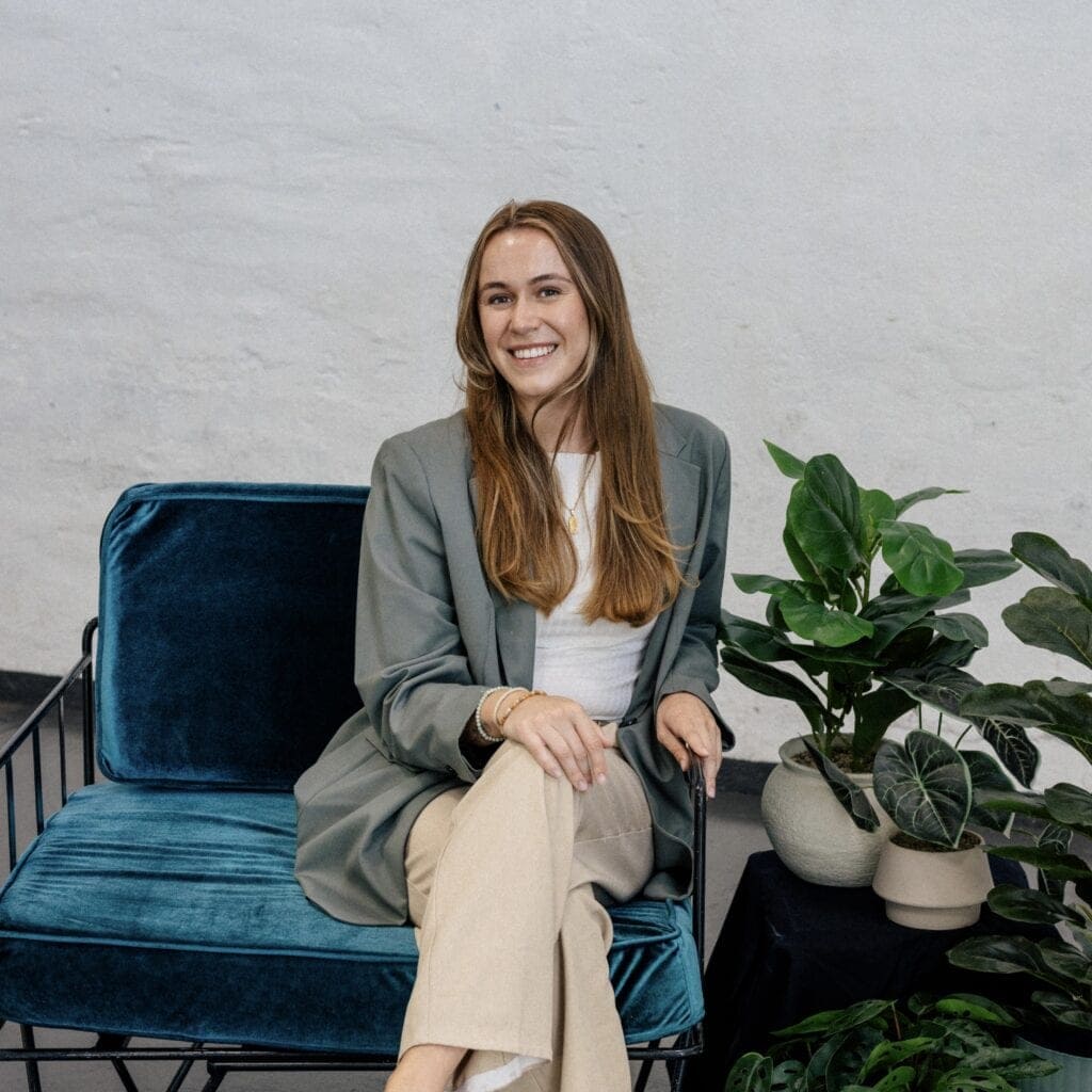 Clairs Keeley Lawyer in Perth, IMG_8691: Woman sits in chair, plants nearby. Family & Commercial Law, Estate Planning.